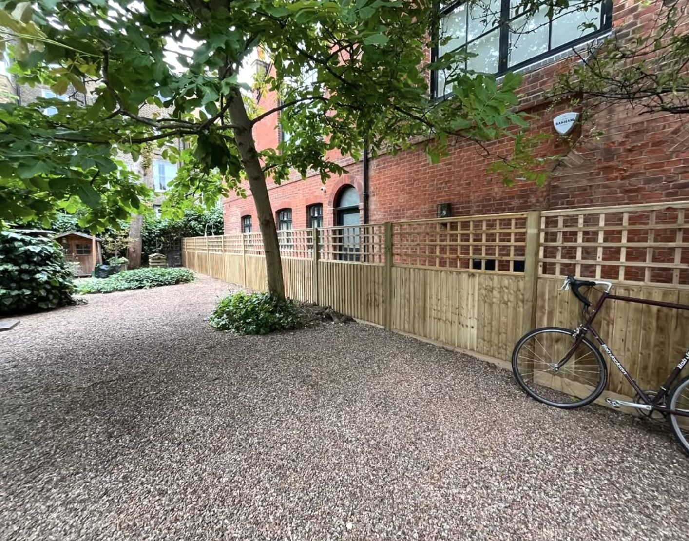 New closeboard fencing with trellis topper installed by landscape gardeners