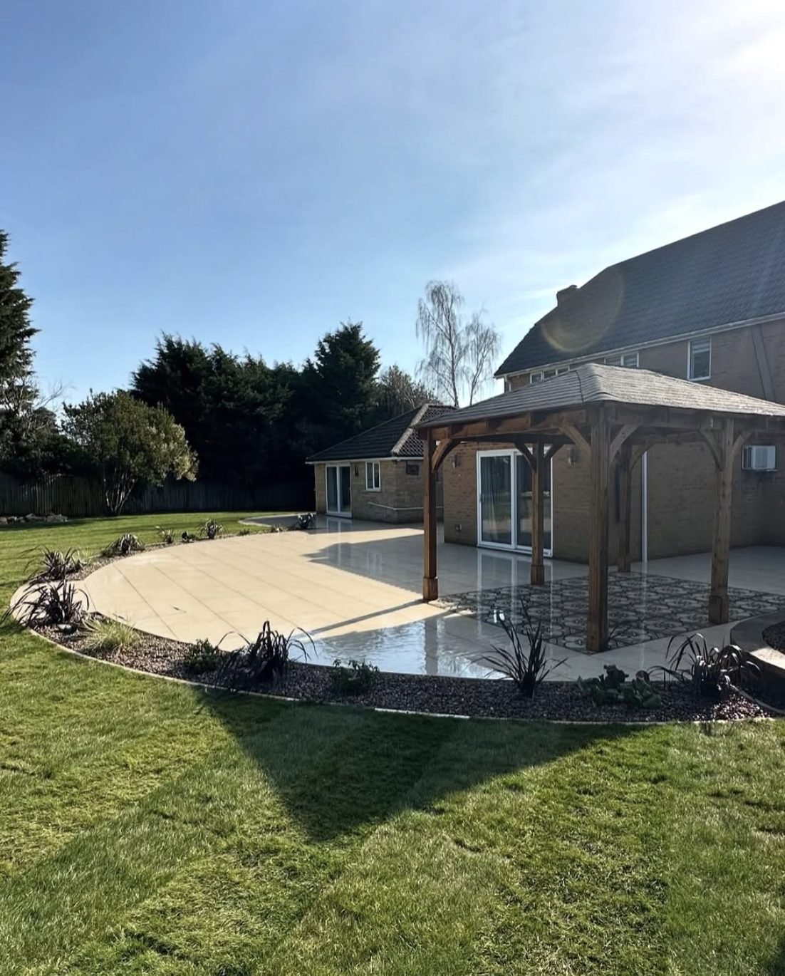 Curved porcelain patio with oak gazebo installed in Hertfordshire